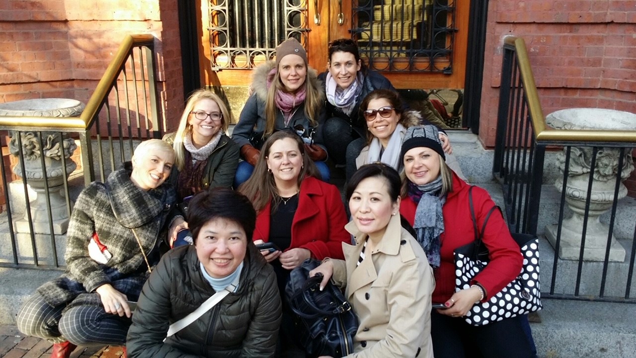 Madison's team sits outside on the steps.