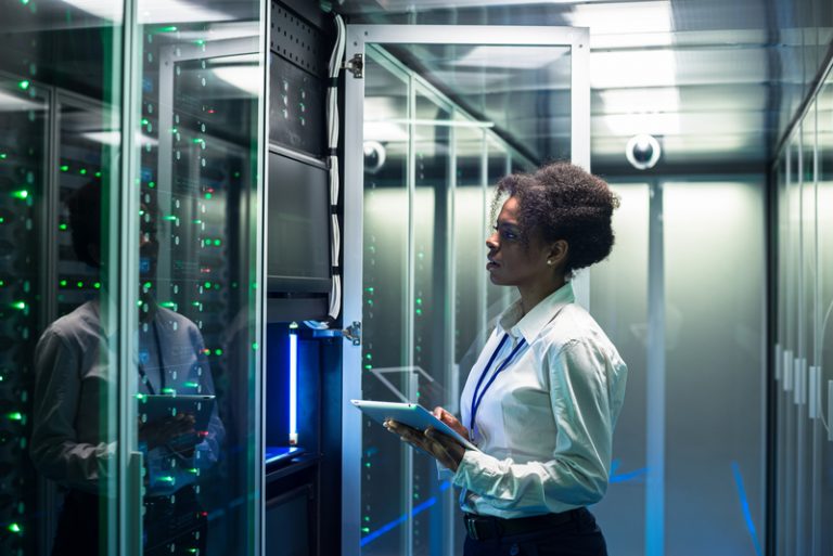A woman working in a server room.