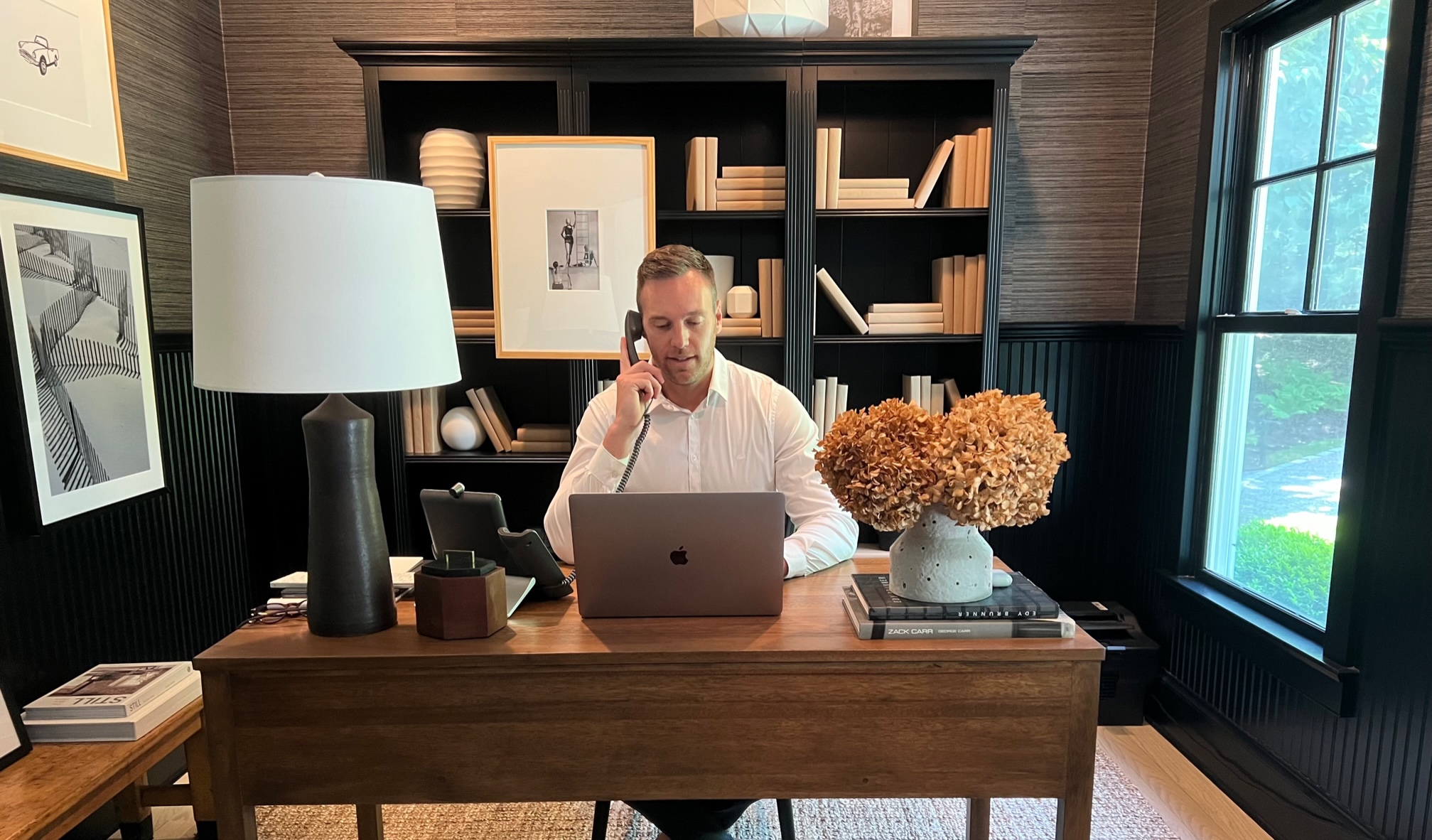 Daniel talking on the phone while working in home office