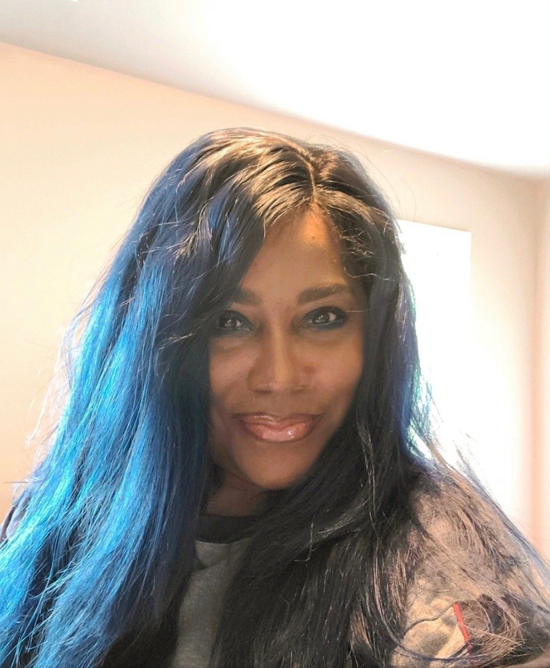 Roz taking a selfie with blue hair 