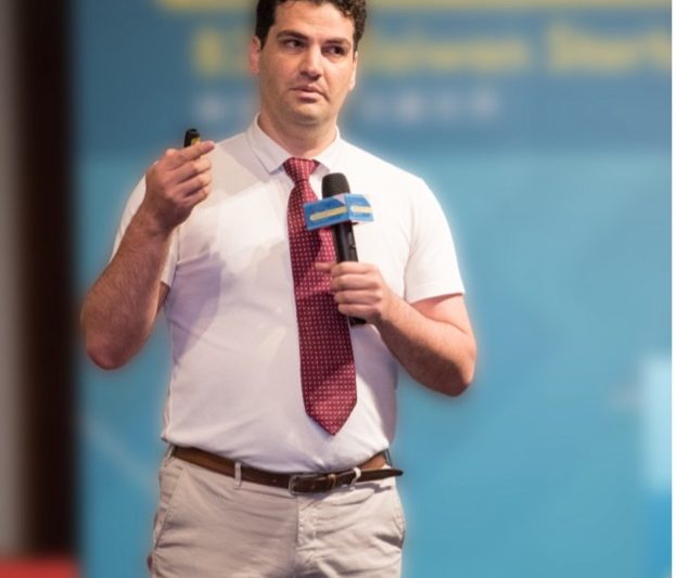 A man wearing a tie while holding a microphone