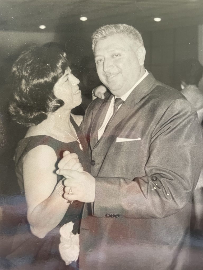 A vintage black and white photo of a couple dancing.