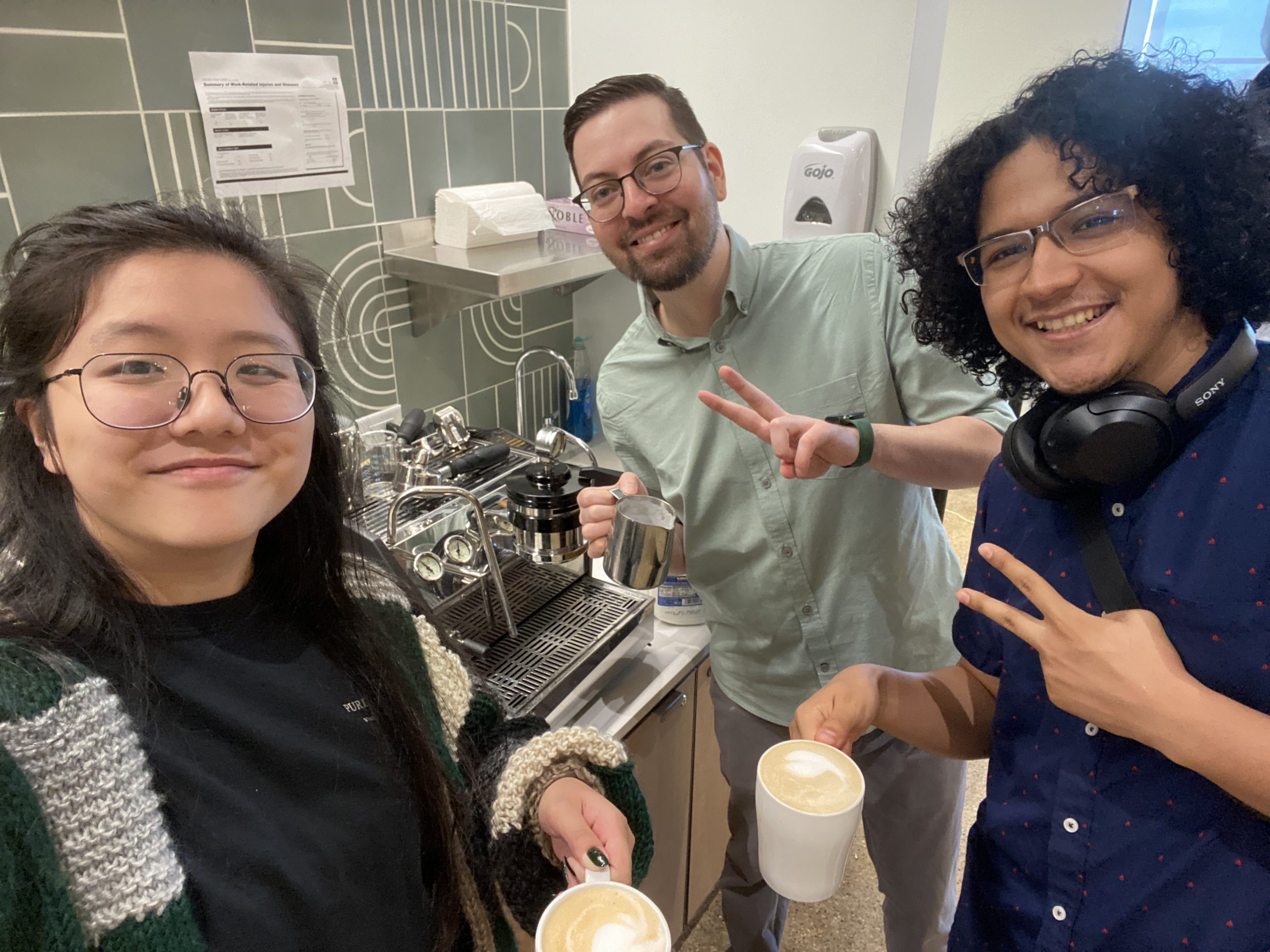 Anna, Felipe, and Angel holding coffees