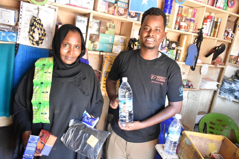 A woman and a man standing side by side in a shop. Photo credit: 