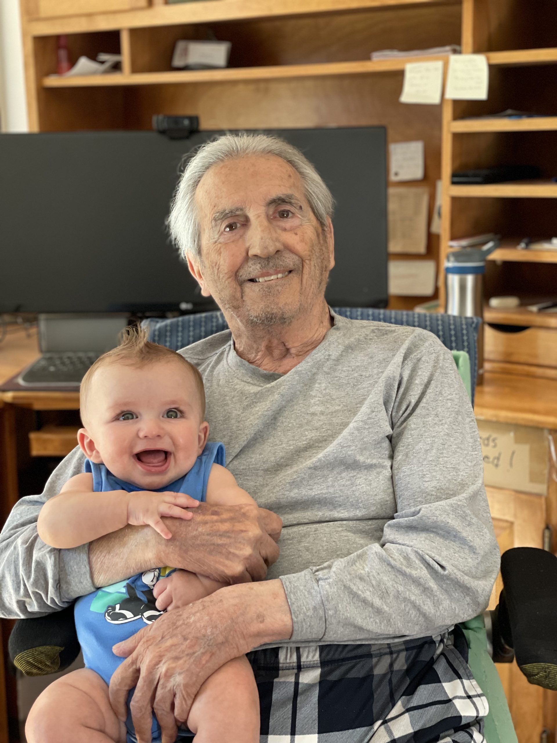 older man holding baby