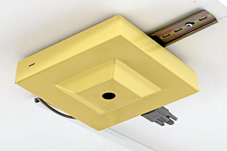 One of Positive Carbon’s food waste sensors installed on a track in the ceiling of a commercial food kitchen