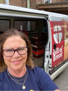 A woman wearing glasses taking a selfie