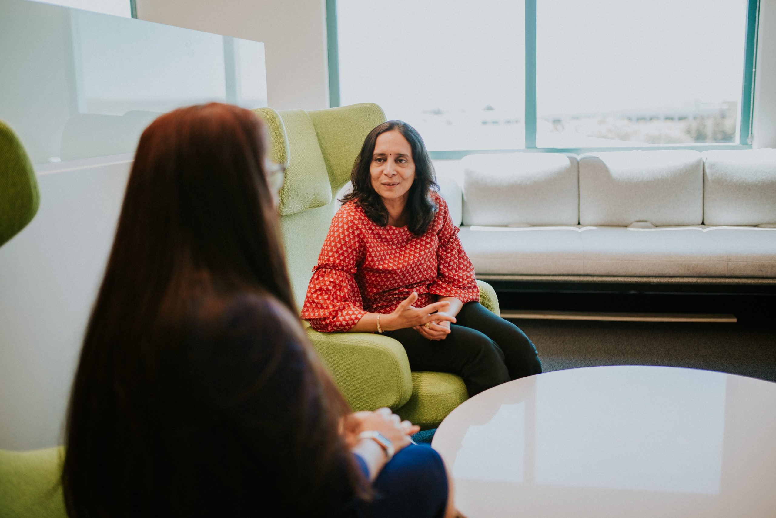 Revathi S. sitting across from someone else.