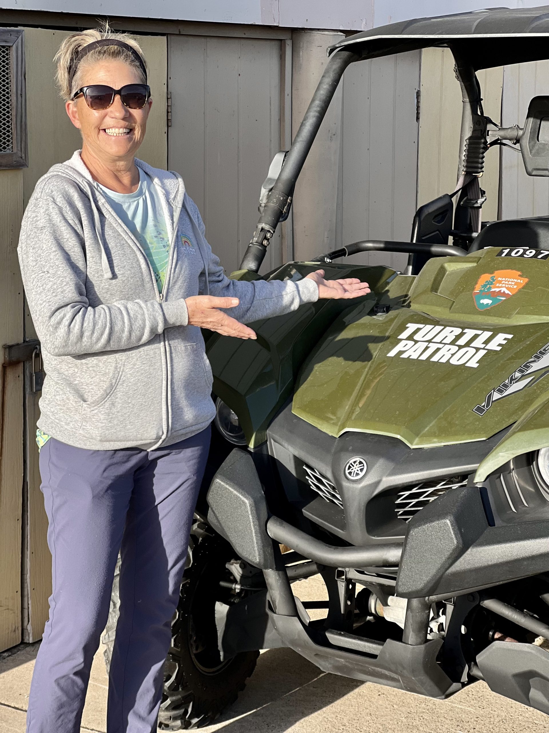 Shawn stands next to a Turtle Patrol vehicle.