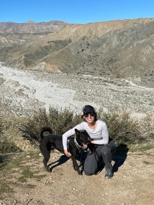 A woman in an outdoor setting with her dog