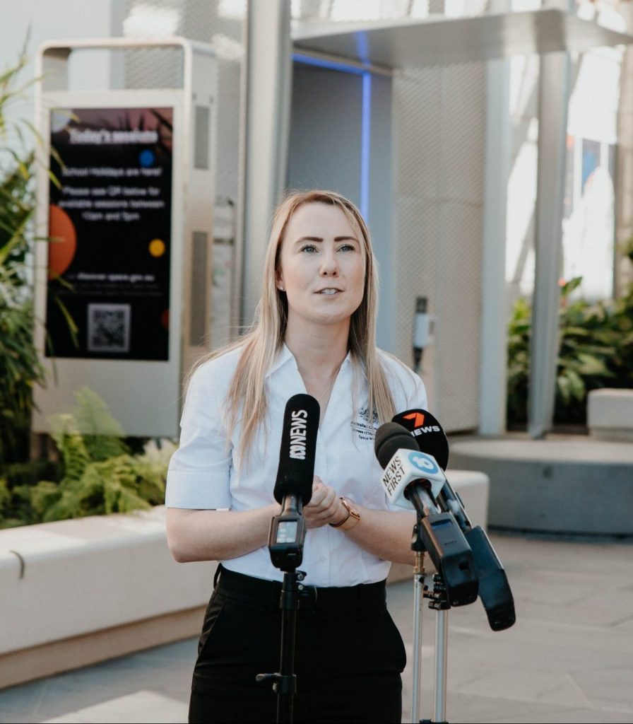 A woman speaking to the press