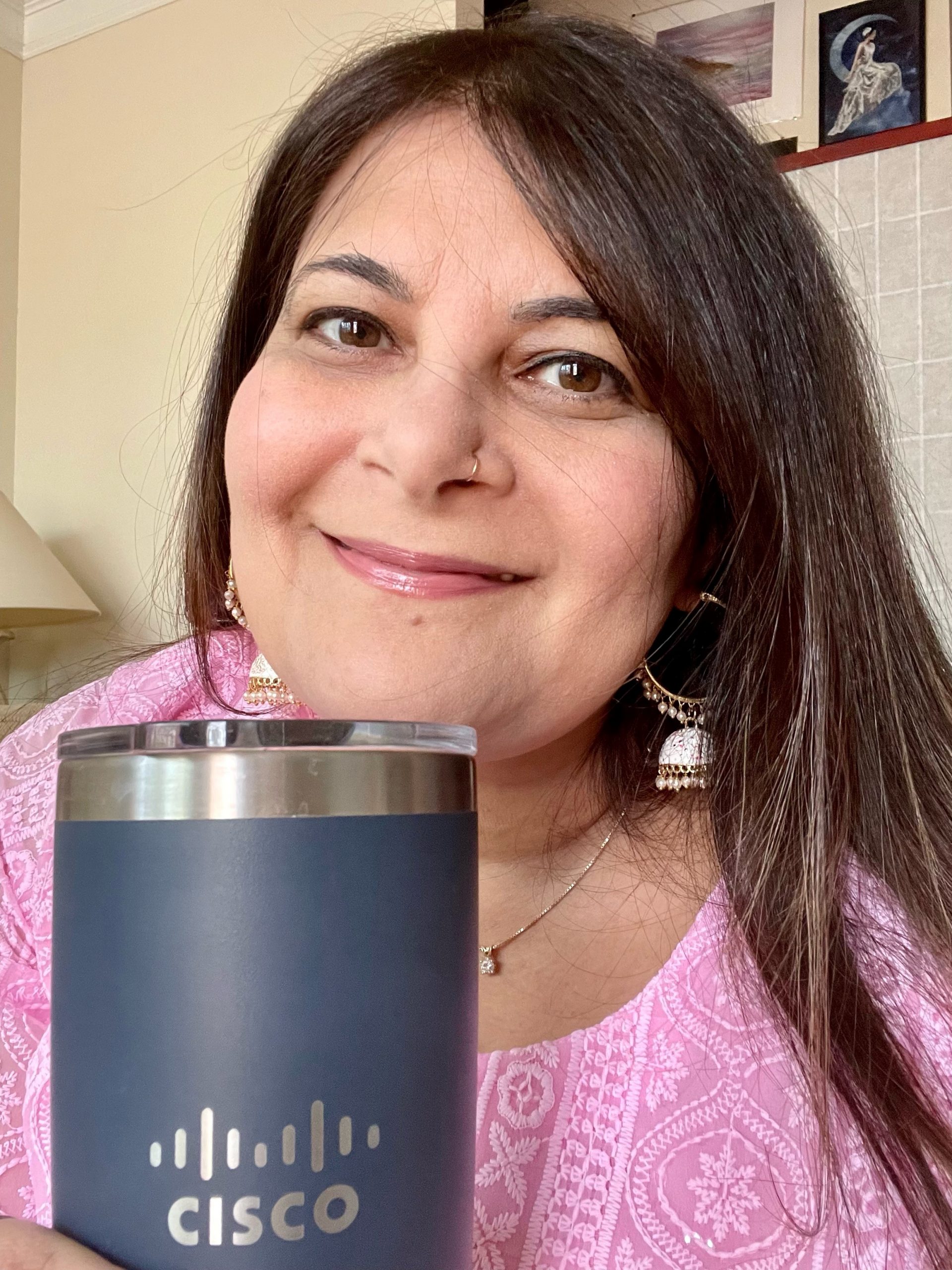 Darshan K. holding a Cisco cup.