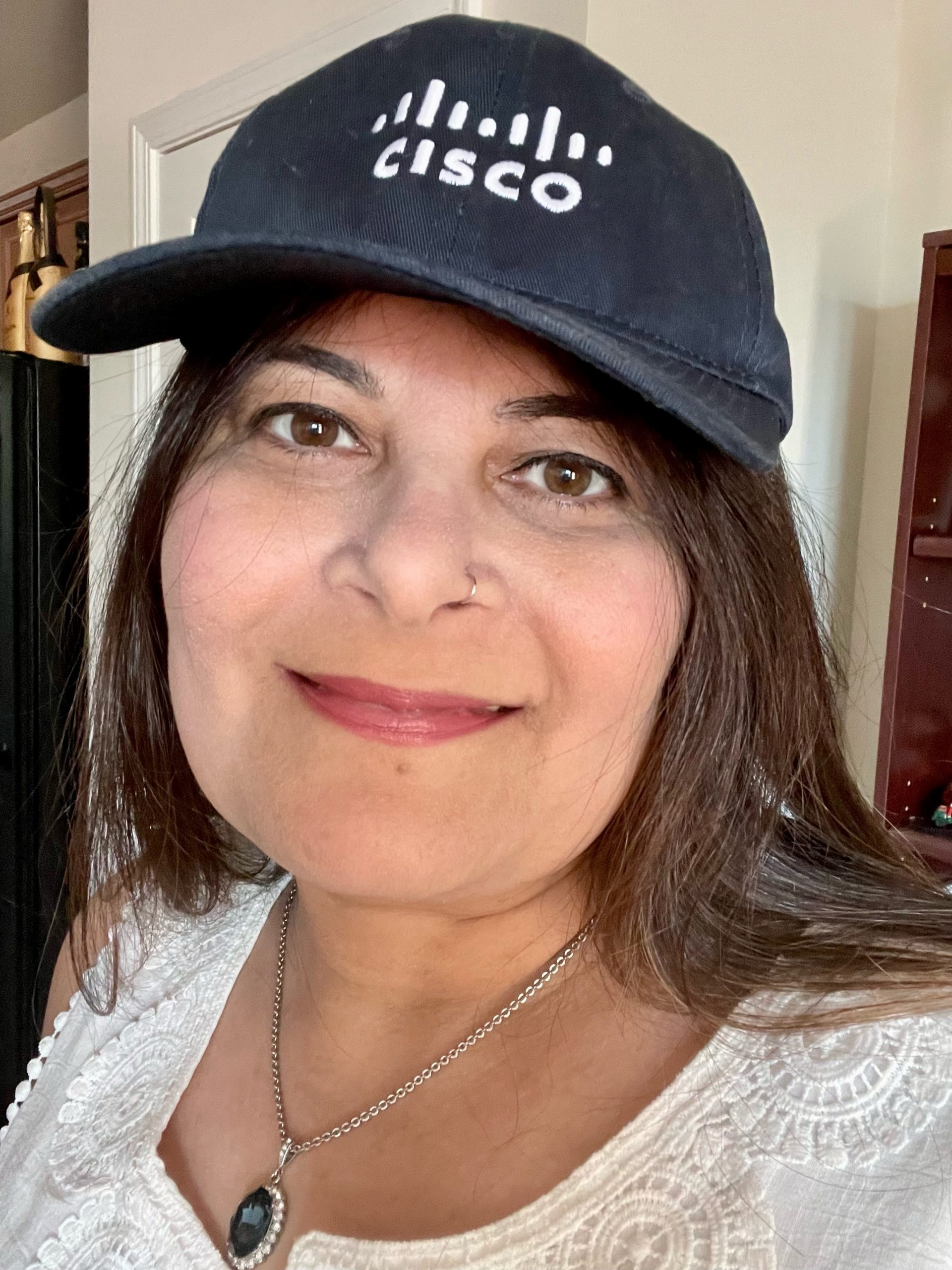 Darshan K. wearing a Cisco baseball hat.