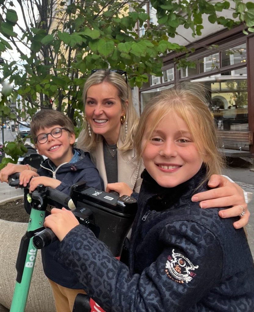 A woman near bicycles with a boy and girl