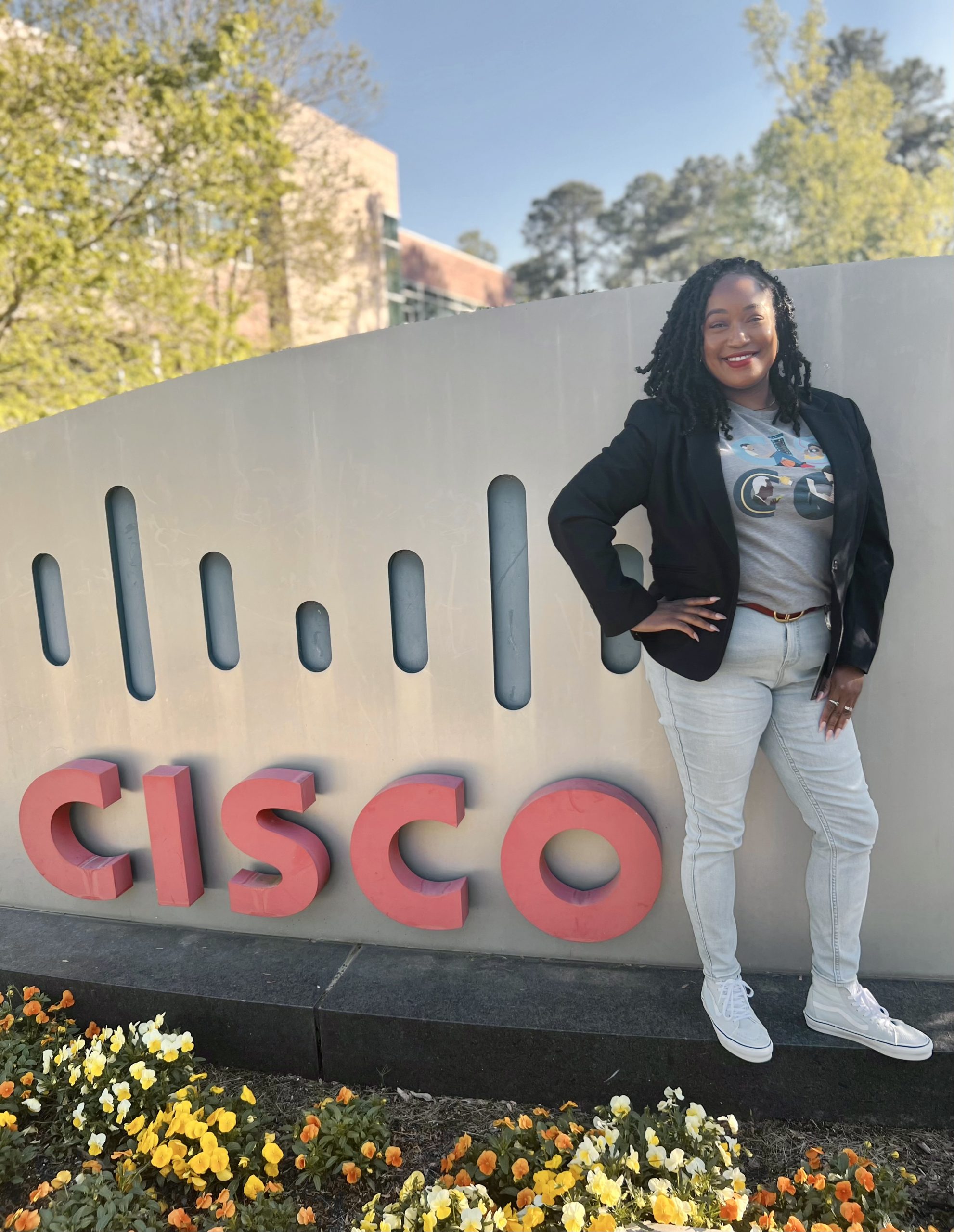 Tiara posing with a "Cisco" sign. 