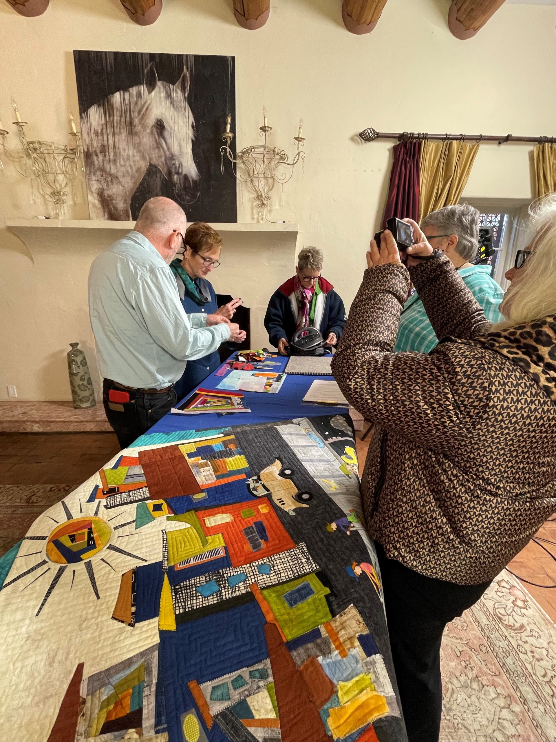 Judy and the film crew setting up the quilts for a shot. 