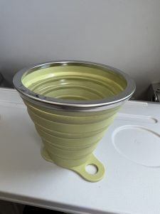 A green reusable water cup