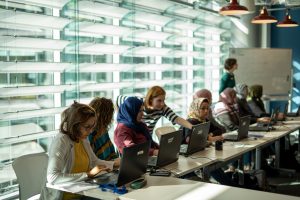 Women using laptops in a classroom setting