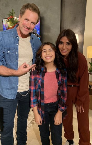 Two adults posing with a child