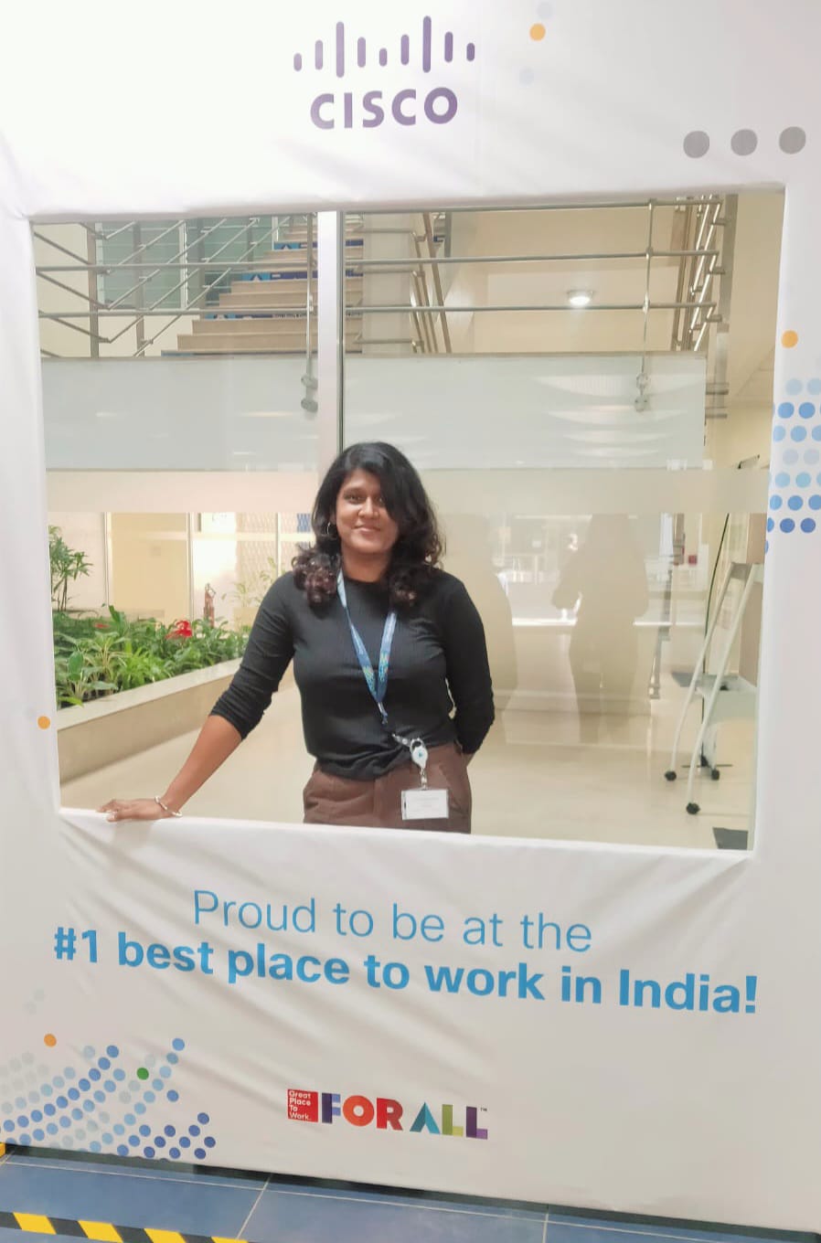 Ruffina standing with a sign that reads, "Proud to be at the #1 best place to work in India."