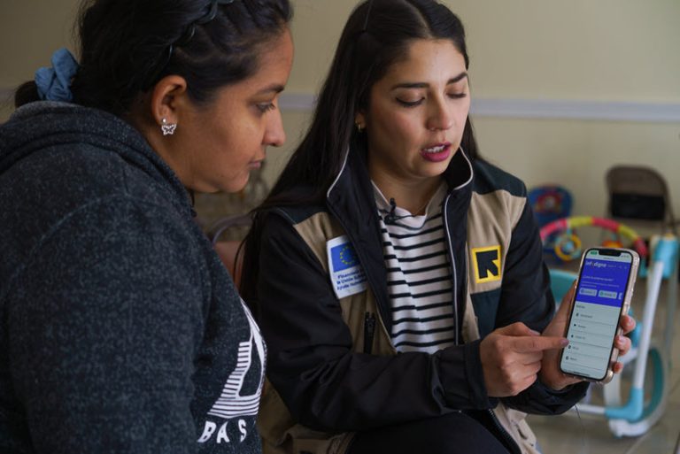 Two women looking at a cell phone