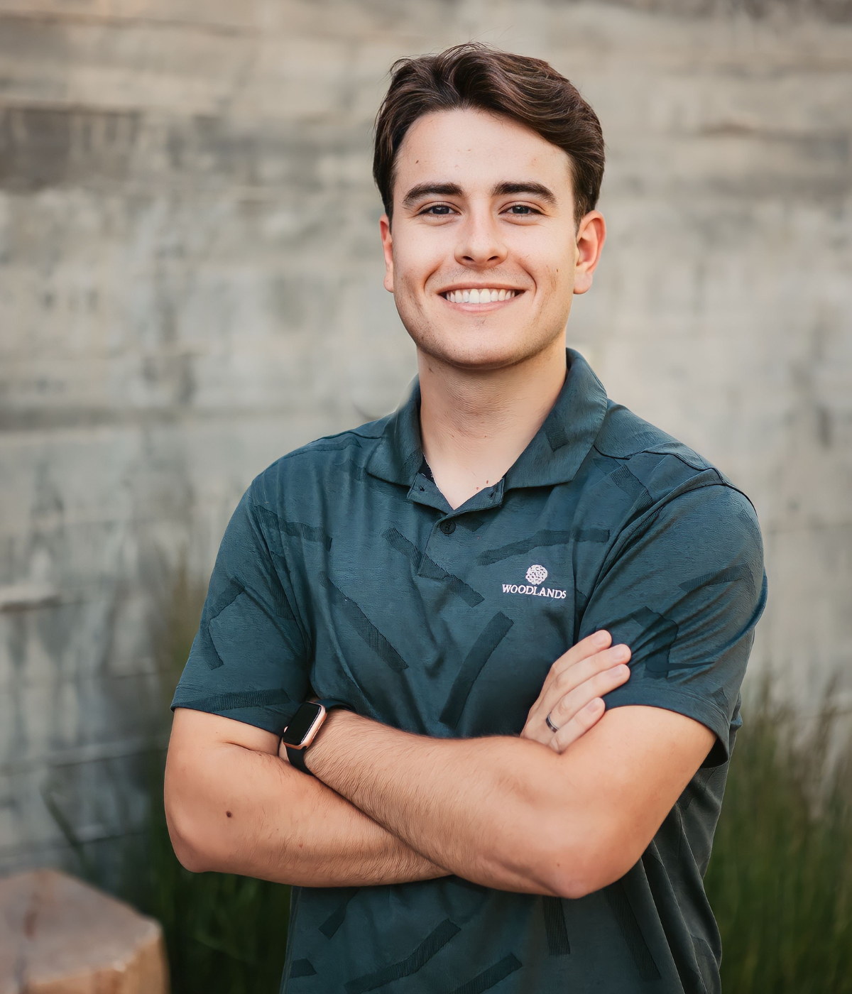 Portrait of Nate smiling with his arms crossed.