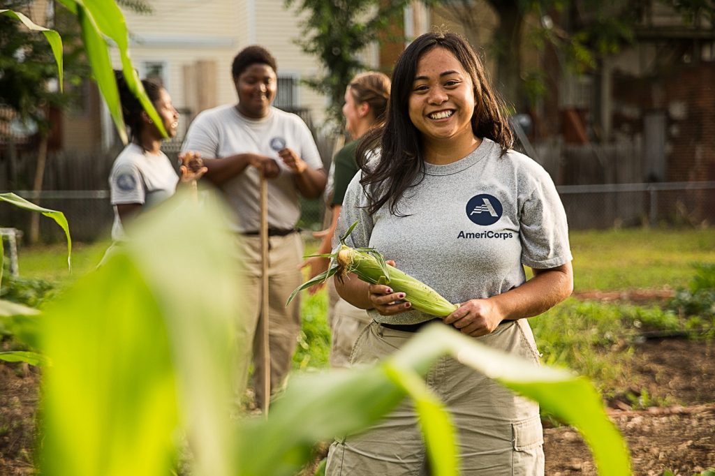 An AmeriCorps member serves in a community garden.