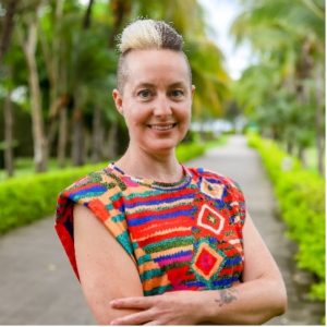 A woman wearing a colorful top