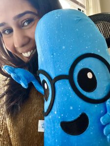 Selfie of Brinda with a Lumi plushie.