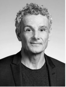 A black and white photo of a man wearing all black