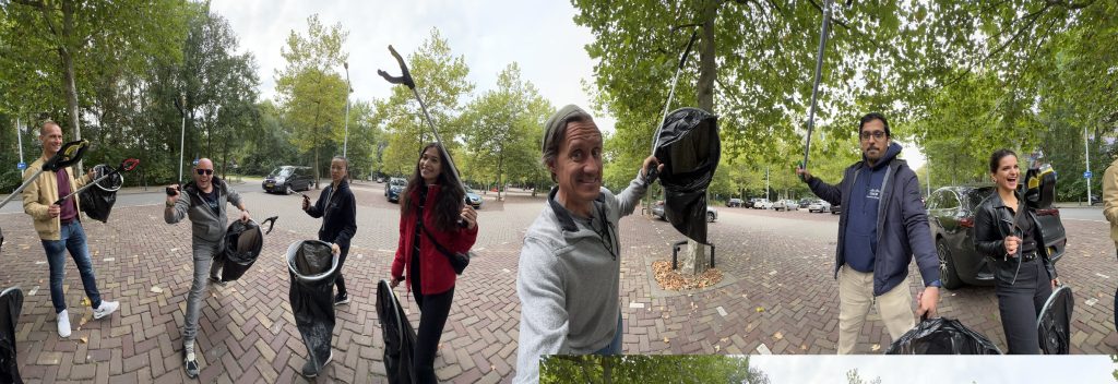 A group of people posing for a photo with green trees behind them