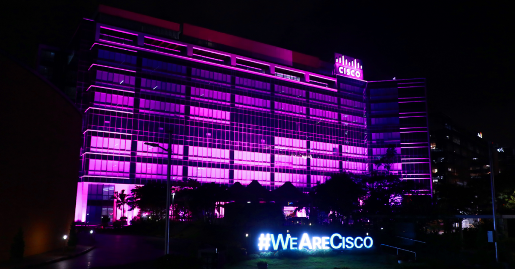 Cisco office building lit up in purple in recognition of #PositivelyPurple and International Day of Persons with Disabilities