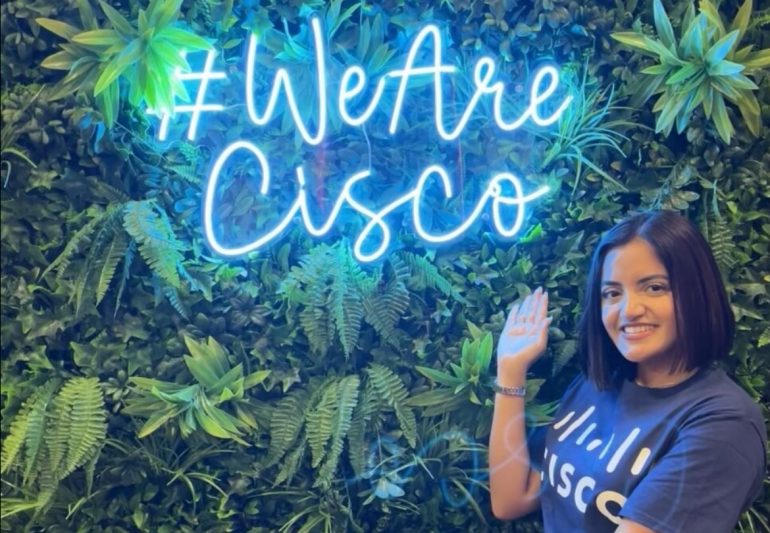 Jassmine next to a #WeAreCisco sign.