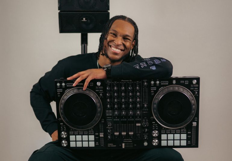 Person holding a DJ keyboard.