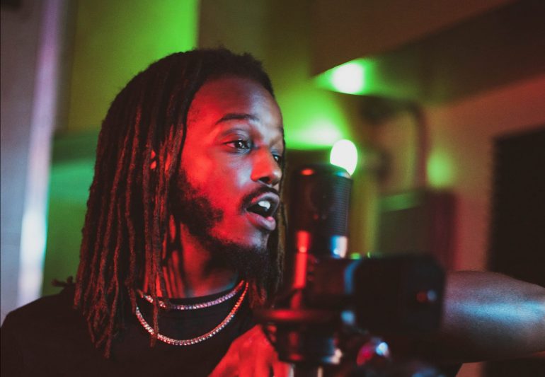 Person singing into a microphone.