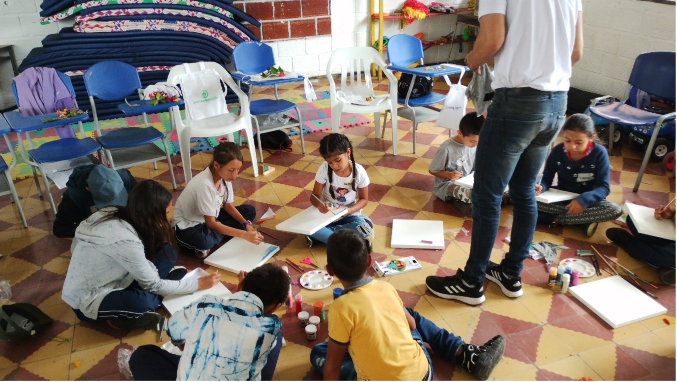 A group of children sitting on a tiled floor, working on a project together