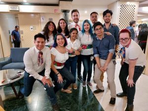 Group of people huddled together/=.