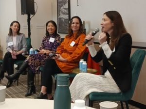 A group of women sitting in chairs holding microphones