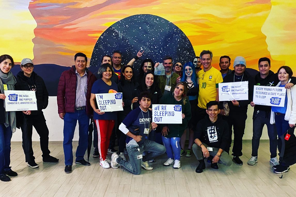 Group of people holding "Cisco Sleep Out" signs.