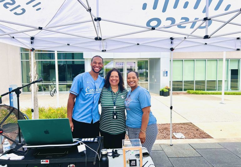 Three people standing together.