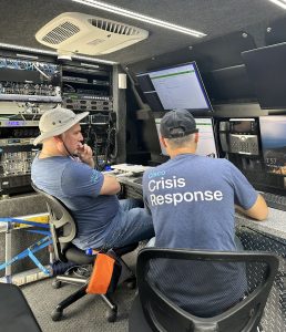 Two workers in NIRV truck looking at monitor
