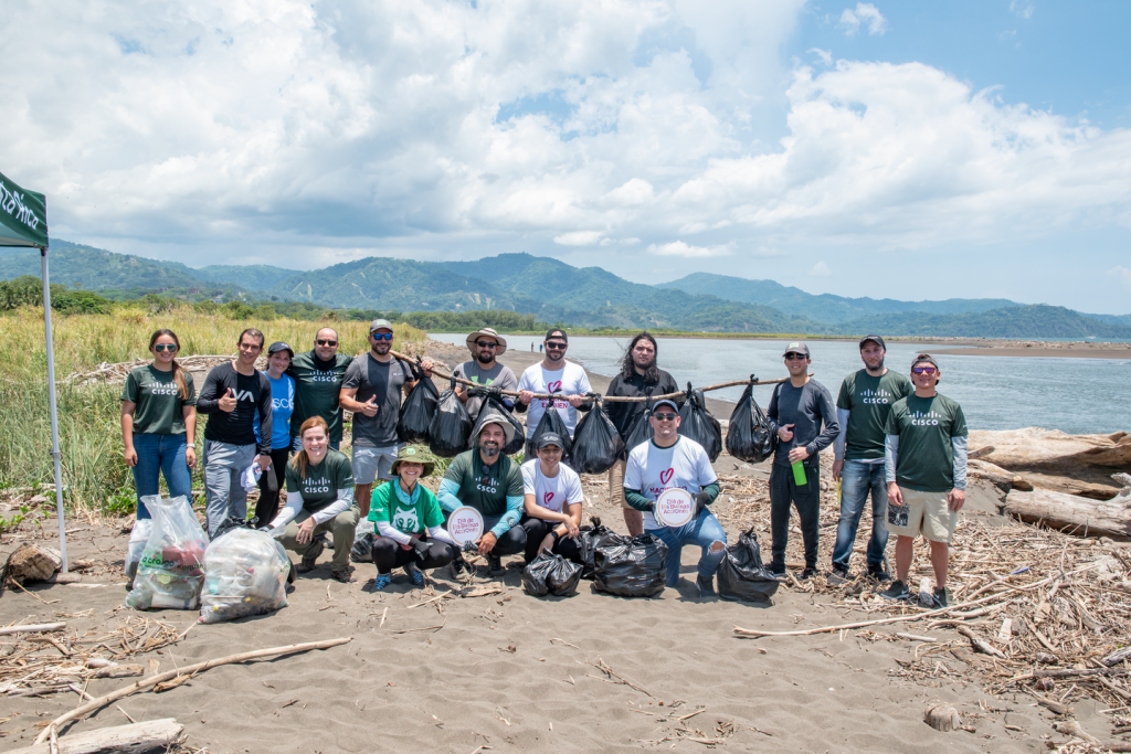 A group of people on a beach at a beach cleanup