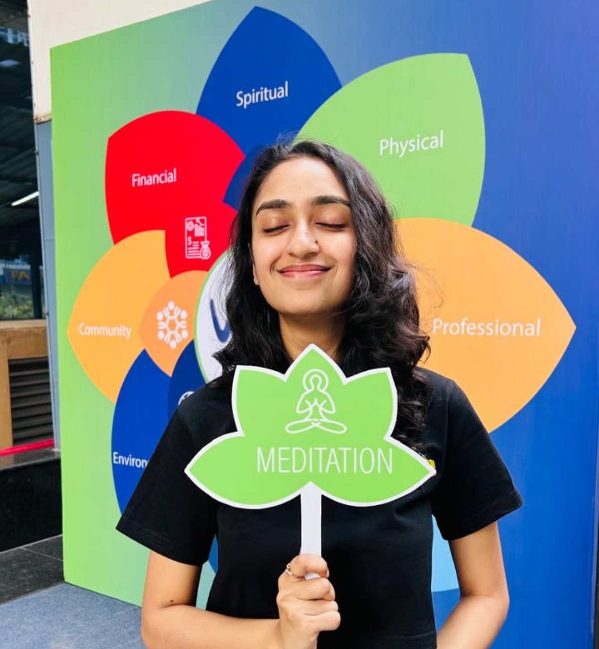 Person holding up a green sign that reads, "Meditation."