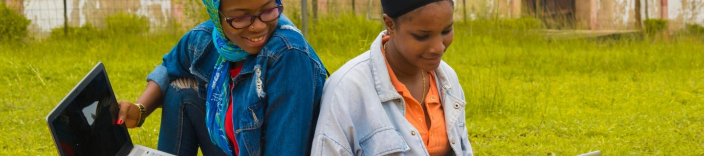 women working on laptops outdoors