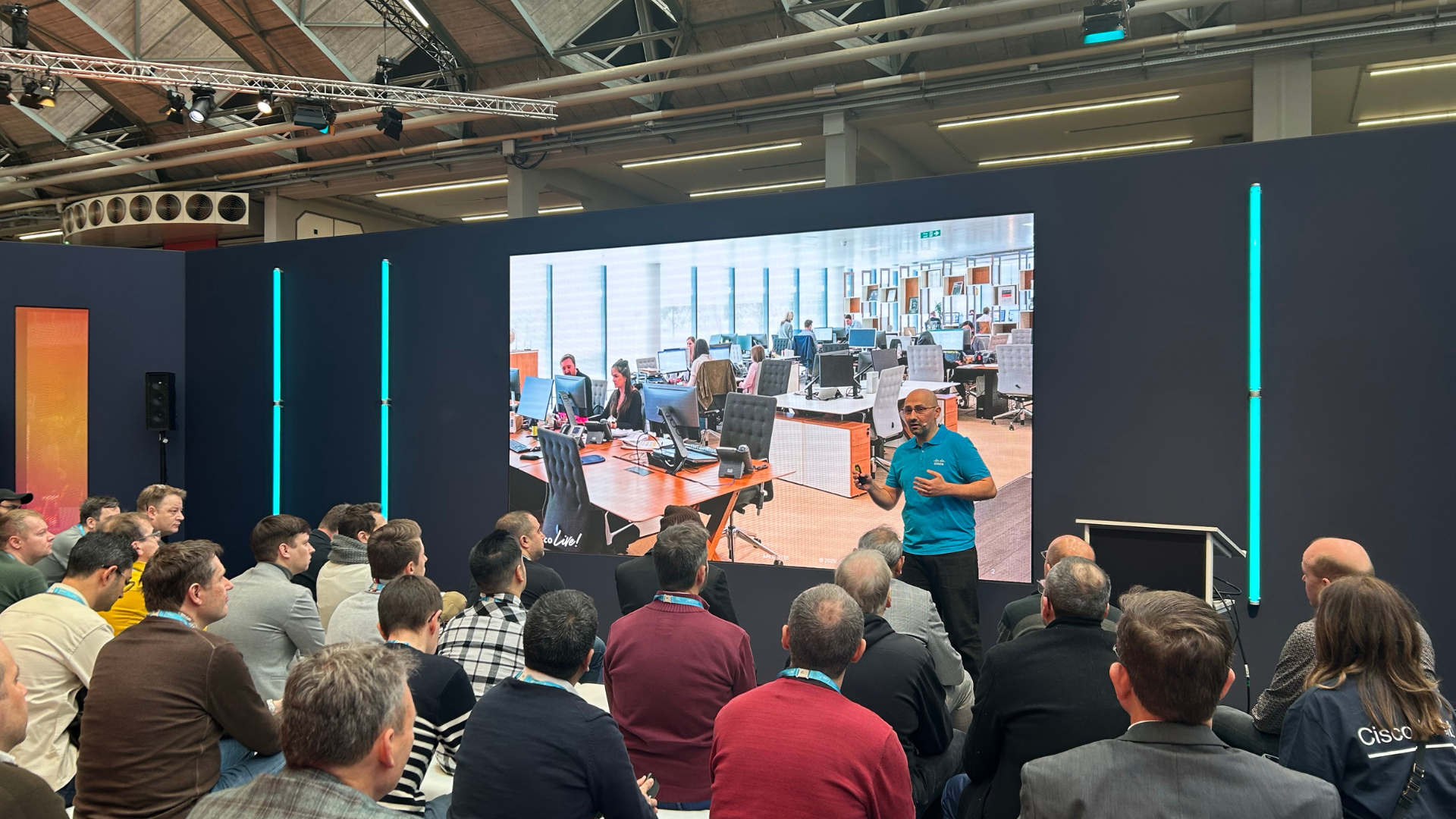 Man standing n front of audience giving a class.
