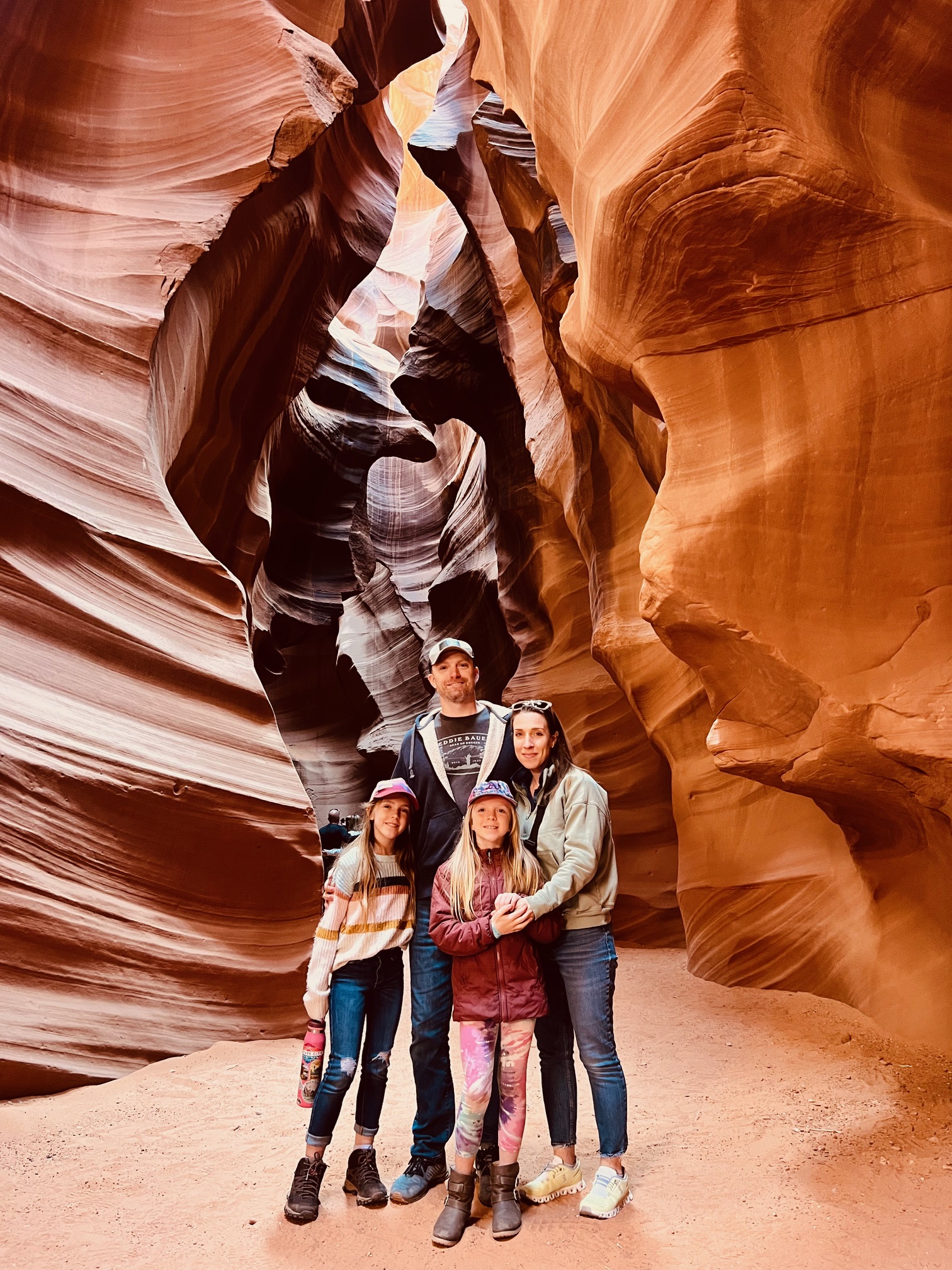 A family of four enjoying some red rock formations.