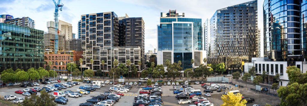 Parking lot of cars near buildings