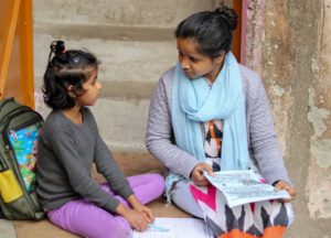 Woman sitting with a small child and talking