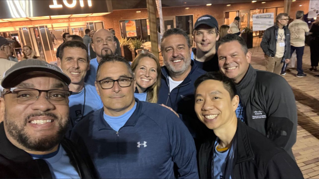 Image of group of nine employees standing outside.