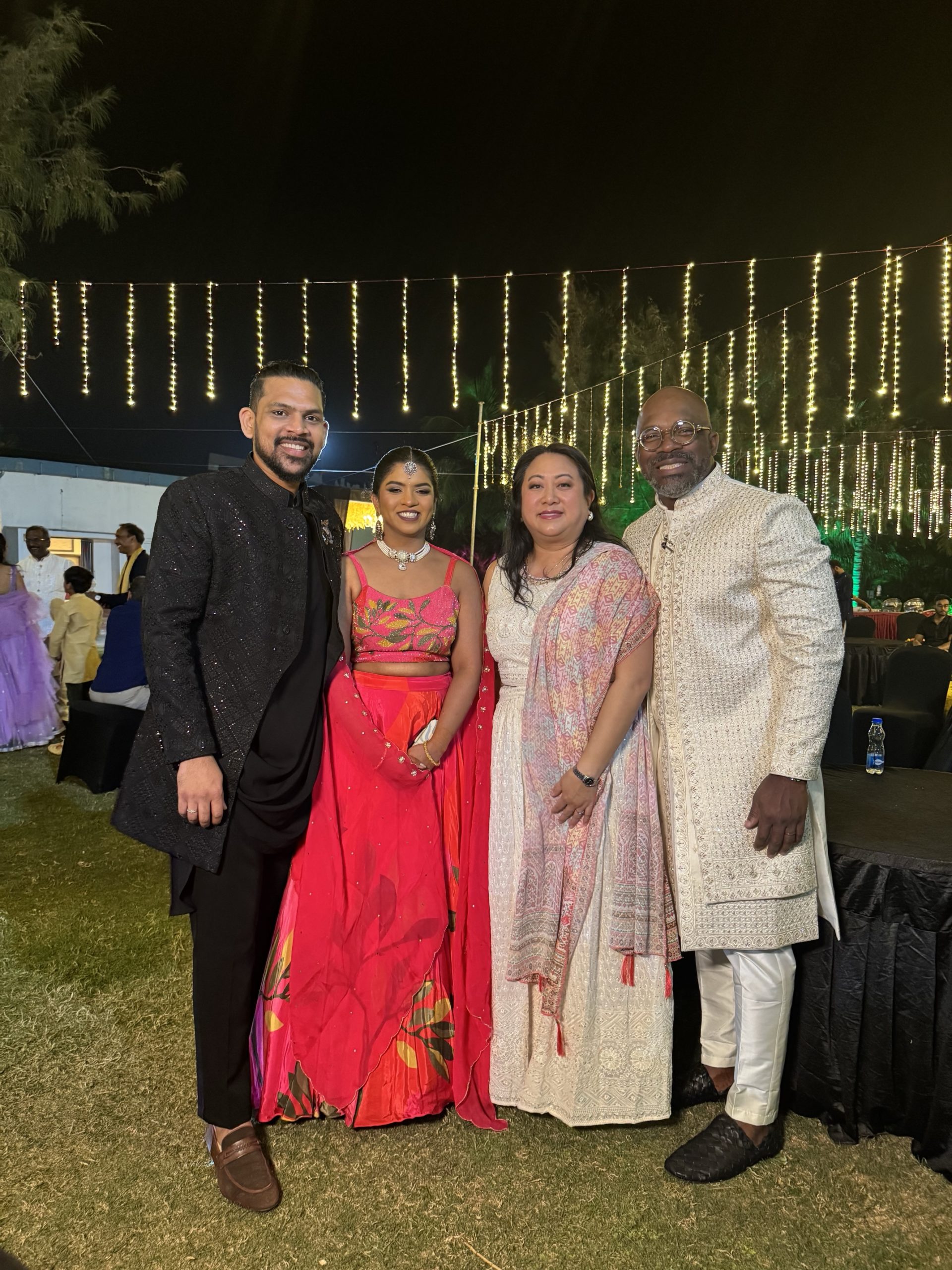 Groom and Bride standing next to a man and woman.